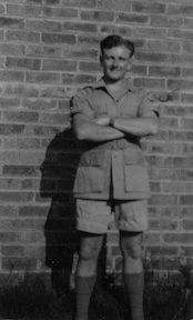 New tropical kit (??) Nigel outside bungalow