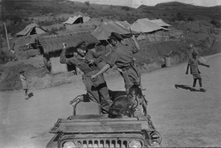 Clive 'Smokey' Entwistle and Dave Gardner have a pretend fight on a jeep.