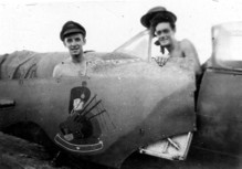 'Jock' Dalrymple, from Aberdeen, holding the piper symbol the airman in the cockpit has just painted.